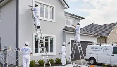 Professional exterior house painters finishing durable siding in Grand Rapids, MI