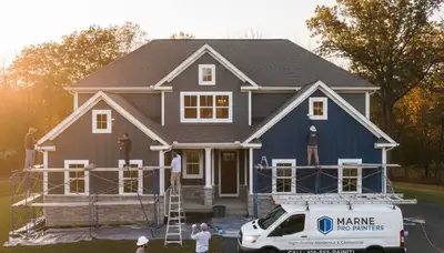 Professional house painters working on residential exterior in Grand Rapids MI
